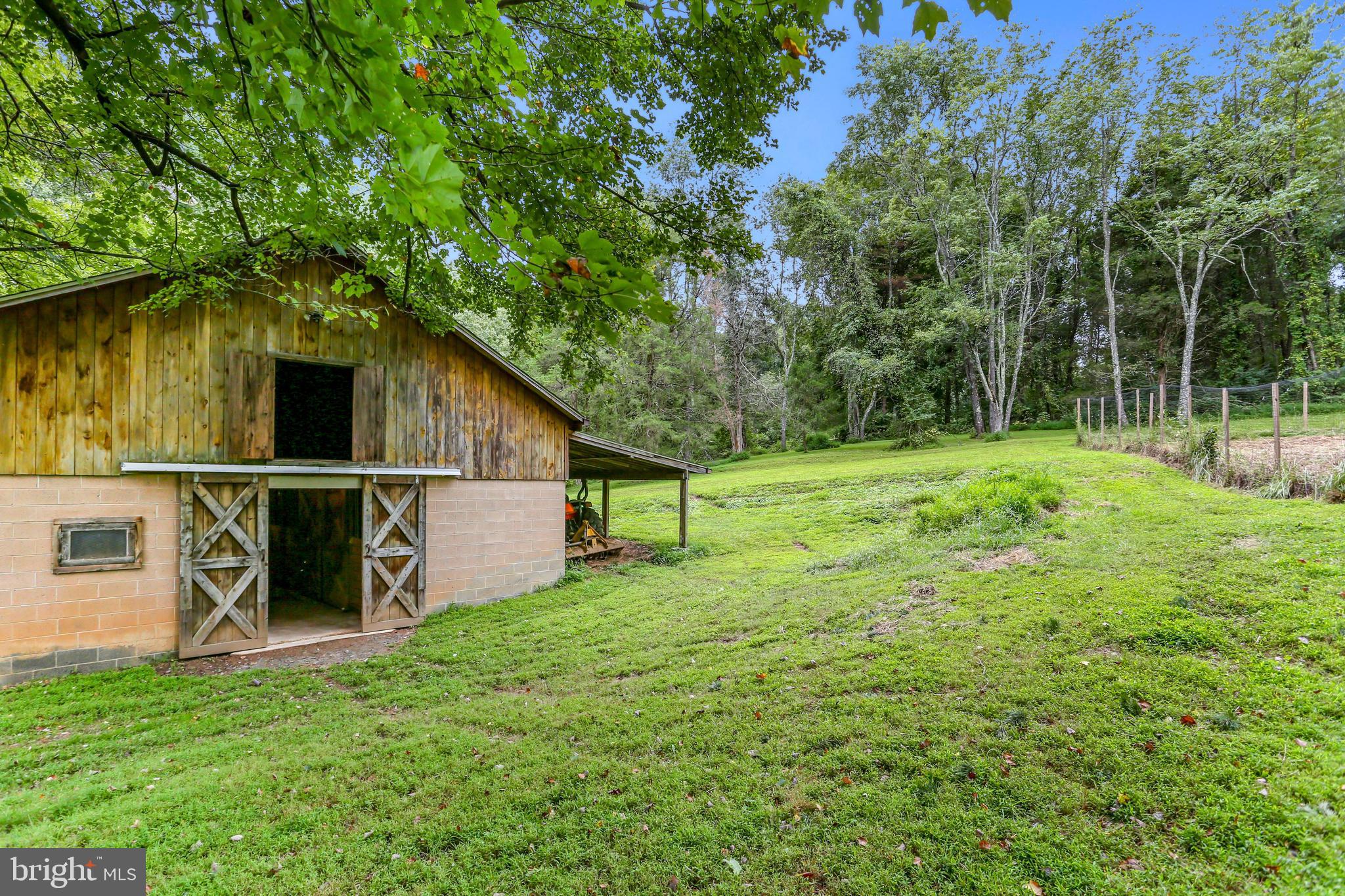 2033 Hunter Mill Road Vienna, VA 22181 - Photo 5 of 5 a view of a backyard with wooden fence and a bench