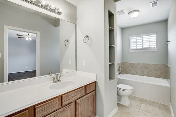 a bathroom with a sink a toilet and bathtub