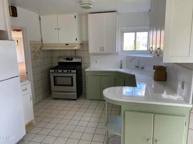 a kitchen with stainless steel appliances granite countertop a sink stove and cabinets