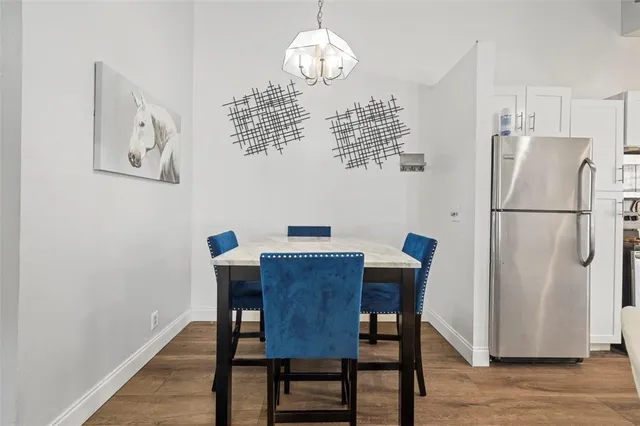 a view of a dining room with furniture wooden floor and a chandelier