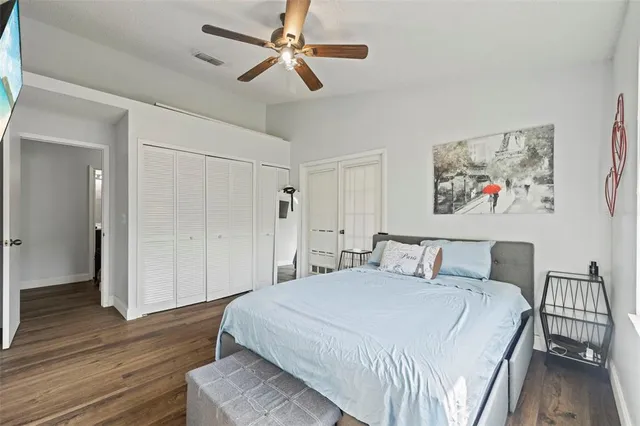 a spacious bedroom with a bed and a chandelier