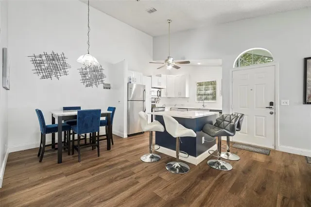 a view of a dining room with furniture a chandelier and wooden floor