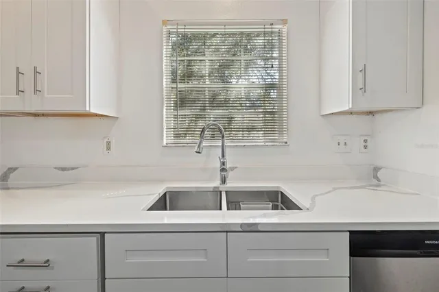 a kitchen with a sink and cabinets