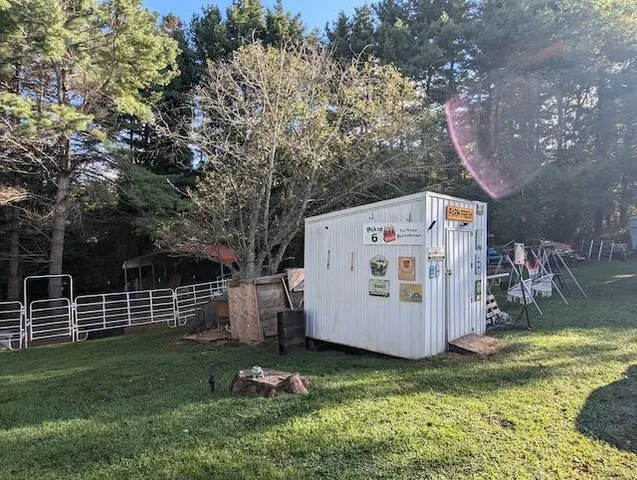 a view of a backyard with open kitchen