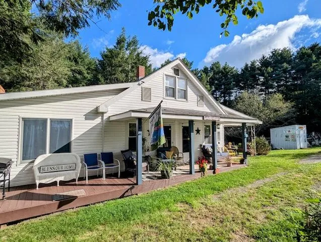 a view of a patio with table and chairs under an umbrella