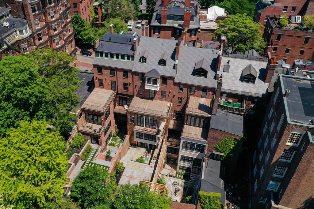 an aerial view of residential houses with outdoor space