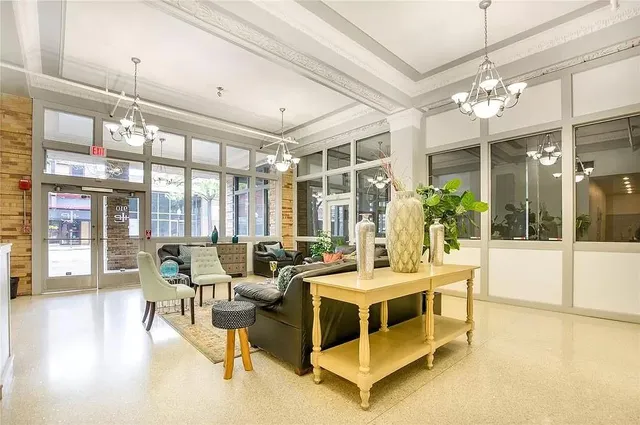 a view of a dining room with furniture a chandelier and wooden floor