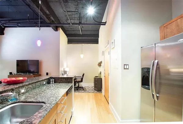 a bathroom with a granite countertop sink and a large mirror