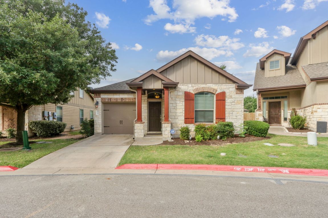 7233 Menchaca Road, Unit 22 Austin, TX 78745 - Photo 1 of 1 a view of a house with a yard and large tree