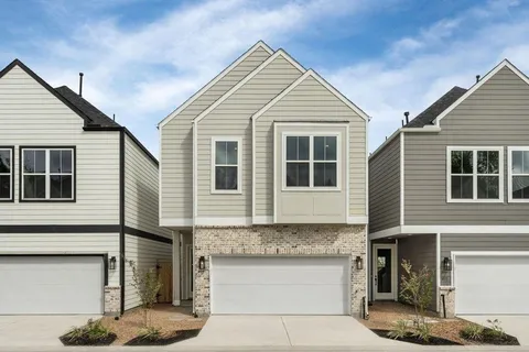 a view of a white house with large windows