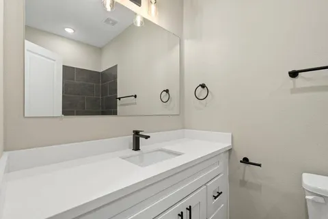 a bathroom with a sink and mirror
