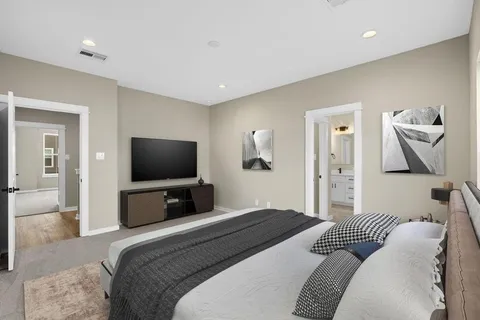 a bedroom with a bed and a flat screen tv
