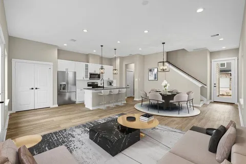 a living room with furniture and kitchen view