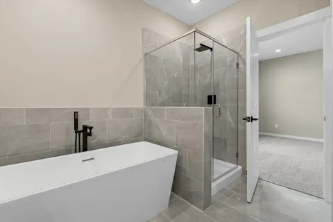 a bathroom with a bathtub and shower