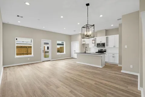 a view of kitchen with granite countertop cabinets and refrigerator