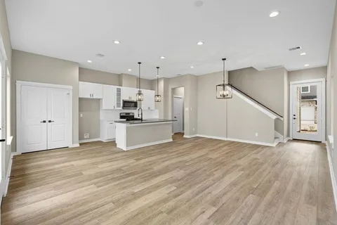 a view of kitchen with wooden floor and electronic appliances