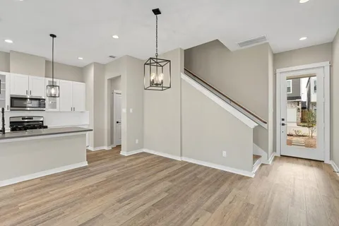 a view of kitchen with sink and wooden floor