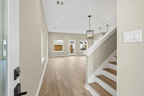 a view of entryway and hall with wooden floor