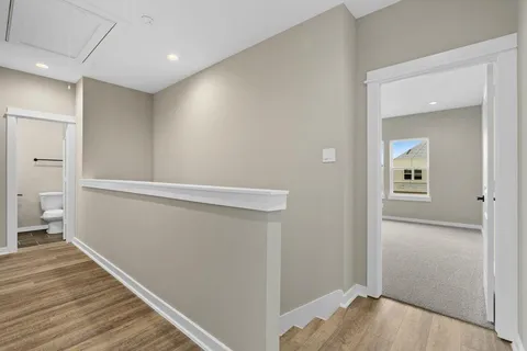 a view of hallway with wooden floor