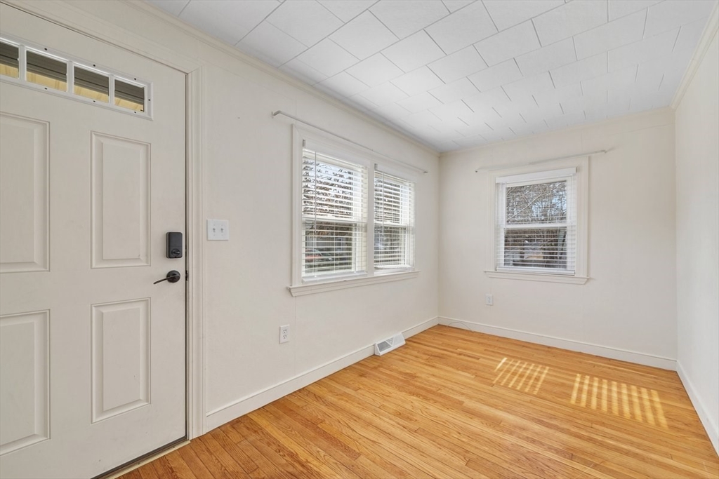 84 East Shore Road Holbrook, MA 02343 - Photo 4 of 26 a view of an empty room with wooden floor and a window