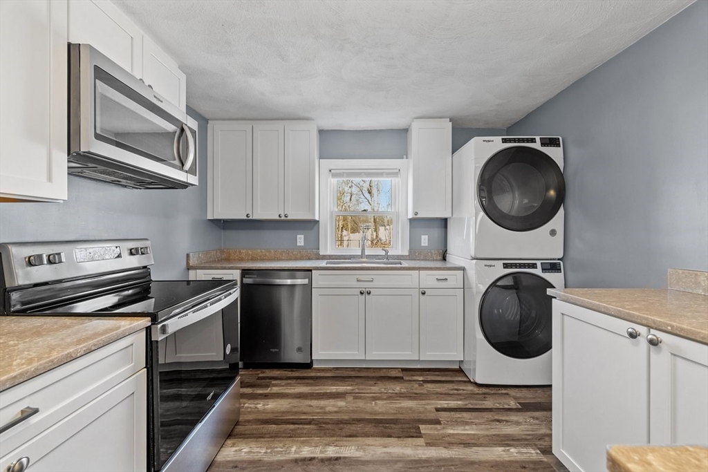 84 East Shore Road Holbrook, MA 02343 - Photo 9 of 26 a kitchen with a stove white cabinets and a sink