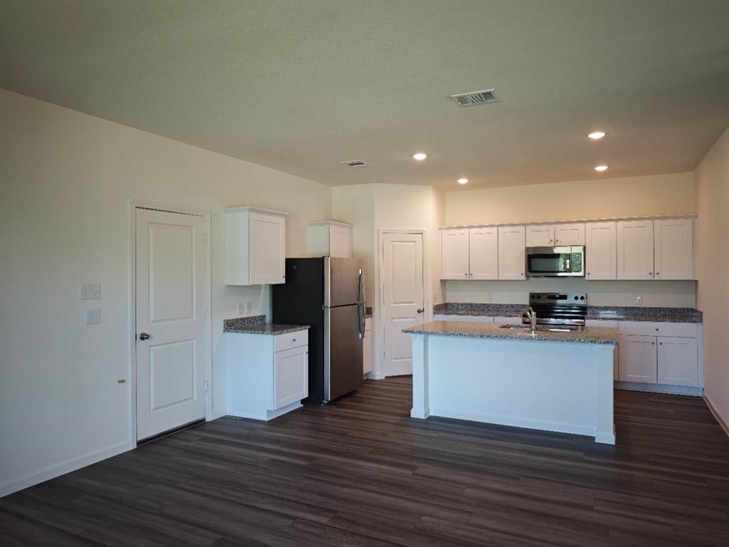 2111 Burnwood Street Melissa, TX 75454 - Photo 4 of 18 a kitchen with stainless steel appliances granite countertop a refrigerator and a stove top oven