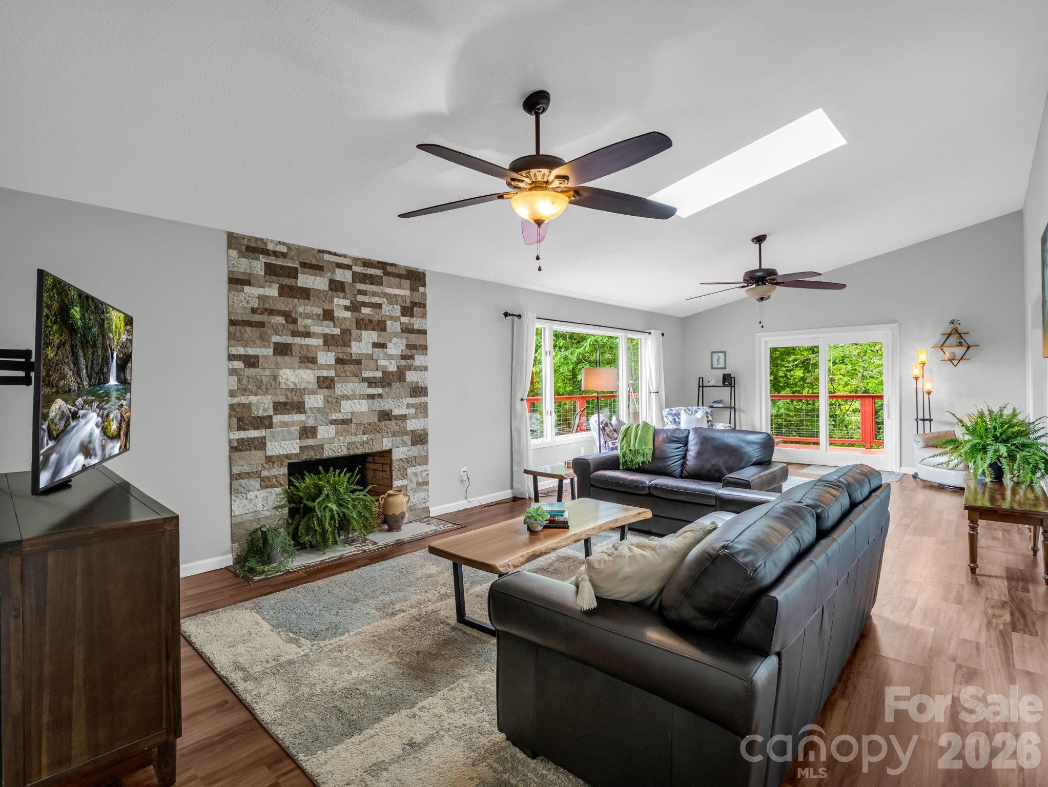 656 Cashiers Valley Road Brevard, NC 28712 - Photo 5 of 37 a living room with furniture and a fireplace