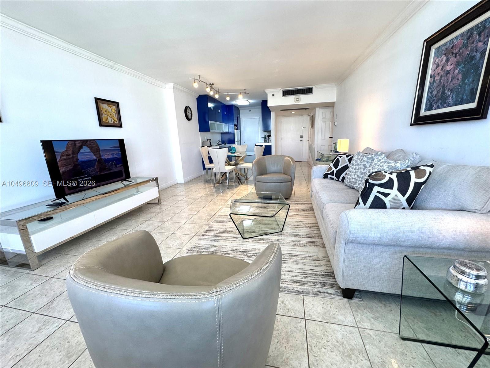 a living room with furniture and a flat screen tv