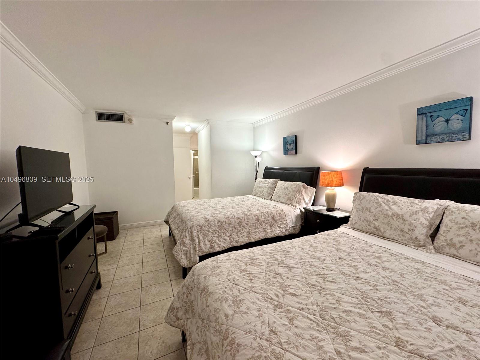 100 Lincoln Road, Unit 1423 Miami Beach, FL 33139 - Photo 11 of 54 a bedroom with two beds and a computer on the desk