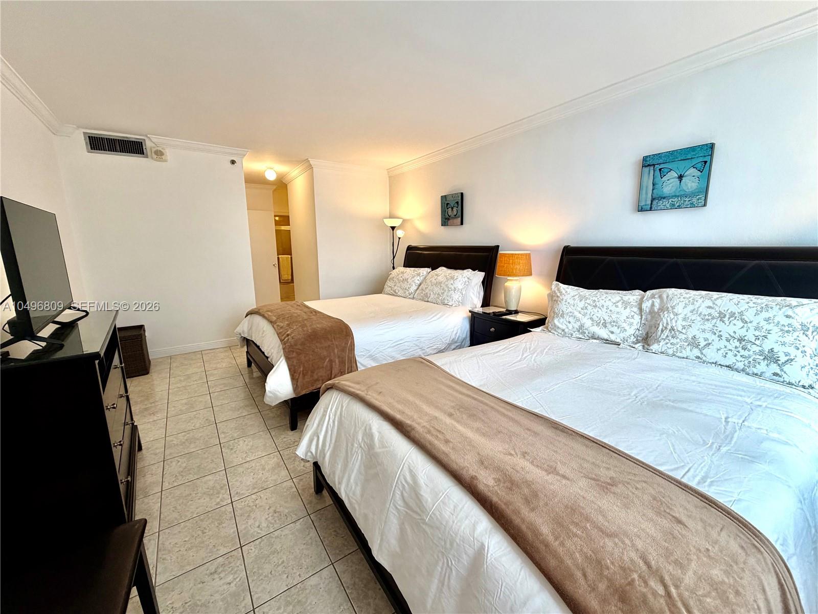 100 Lincoln Road, Unit 1423 Miami Beach, FL 33139 - Photo 14 of 56 a bedroom with two beds and a night stand