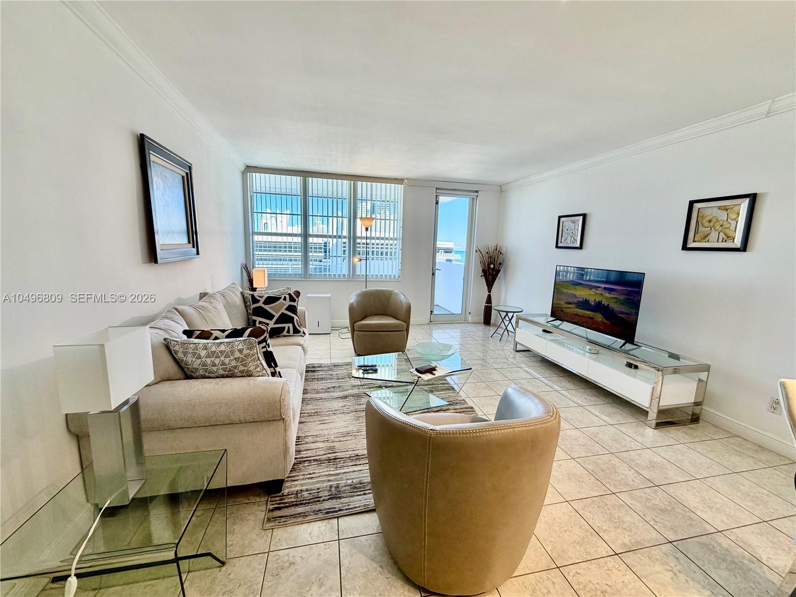 100 Lincoln Road, Unit 1423 Miami Beach, FL 33139 - Photo 2 of 8 a living room with furniture and a flat screen tv