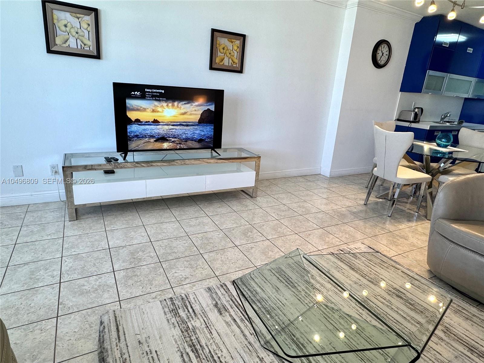 100 Lincoln Road, Unit 1423 Miami Beach, FL 33139 - Photo 3 of 8 a living room with furniture and a flat screen tv