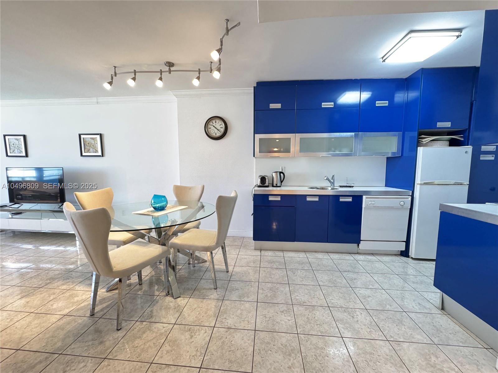 100 Lincoln Road, Unit 1423 Miami Beach, FL 33139 - Photo 4 of 54 a kitchen with a table chairs and wooden floor
