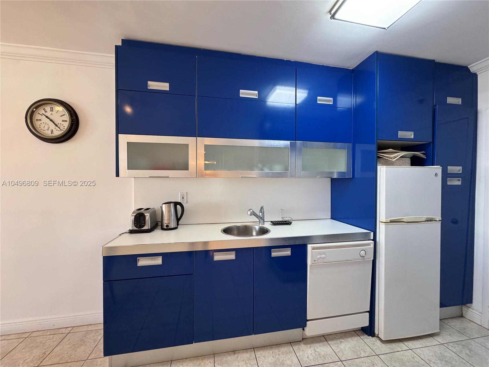 100 Lincoln Road, Unit 1423 Miami Beach, FL 33139 - Photo 5 of 54 a view of a kitchen with a sink and a refrigerator