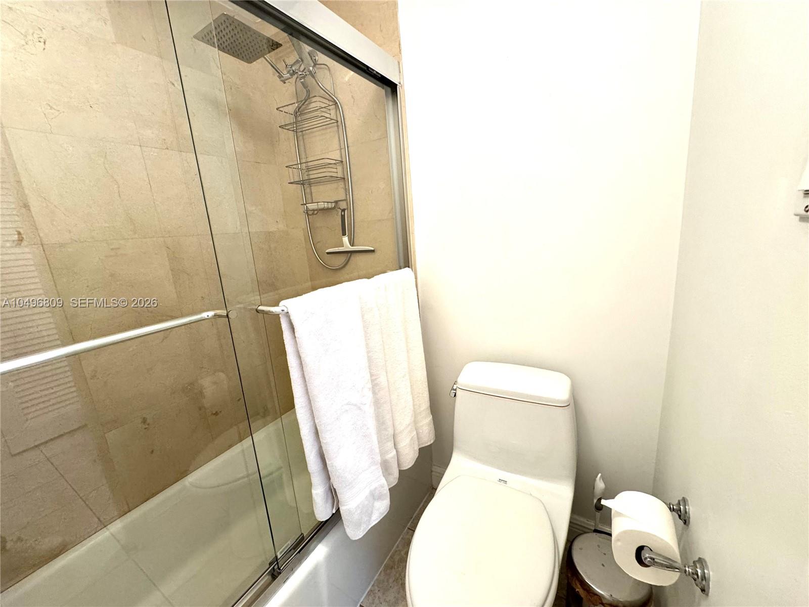 100 Lincoln Road, Unit 1423 Miami Beach, FL 33139 - Photo 6 of 8 a white toilet sitting next to a shower