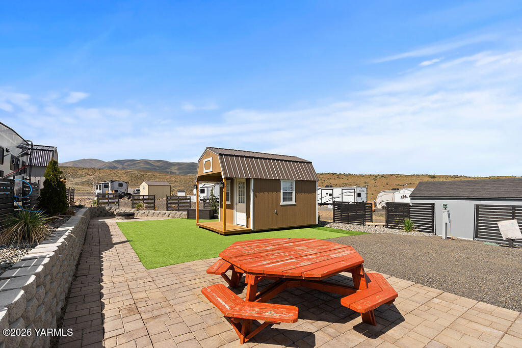 a backyard of a house with yard barbeque oven and outdoor seating