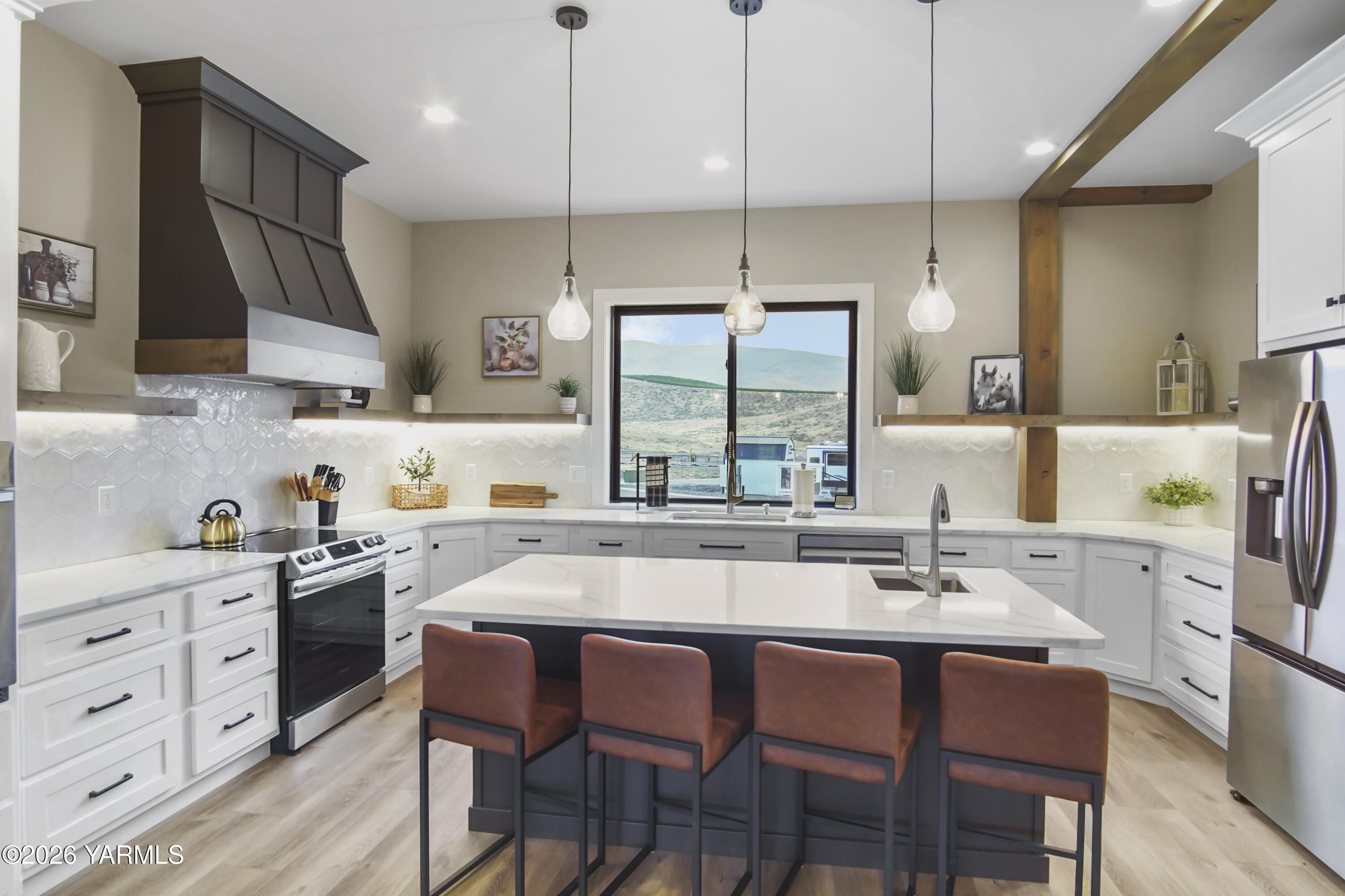1769 Naches Wenas Road, Unit 6 Selah, WA 98942 - Photo 10 of 11 a kitchen with a stove a sink a dining table and chairs
