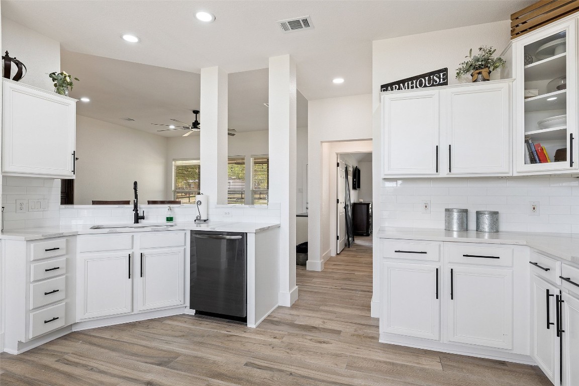 213 Beauchamp Road Dripping Springs, TX 78620 - Photo 12 of 40 a large white kitchen with stainless steel appliances kitchen island granite countertop a refrigerator and cabinets