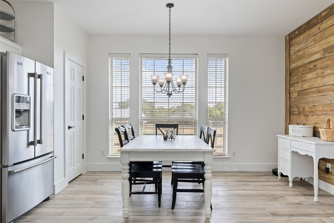213 Beauchamp Road Dripping Springs, TX 78620 - Photo 13 of 40 a dining room with furniture window wooden floor