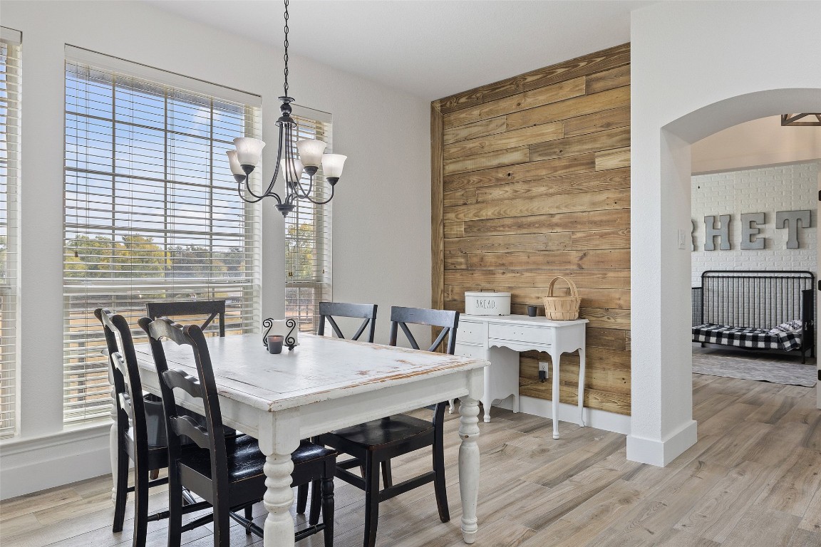 213 Beauchamp Road Dripping Springs, TX 78620 - Photo 14 of 40 a view of a dining room with furniture and wooden floor
