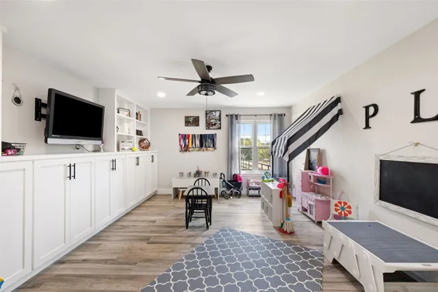 a living room with furniture and flat screen tv