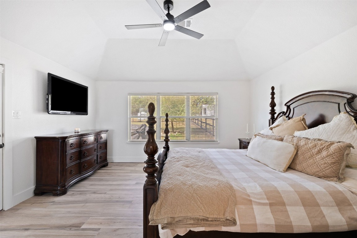 213 Beauchamp Road Dripping Springs, TX 78620 - Photo 17 of 40 a bedroom with a bed and a flat screen tv