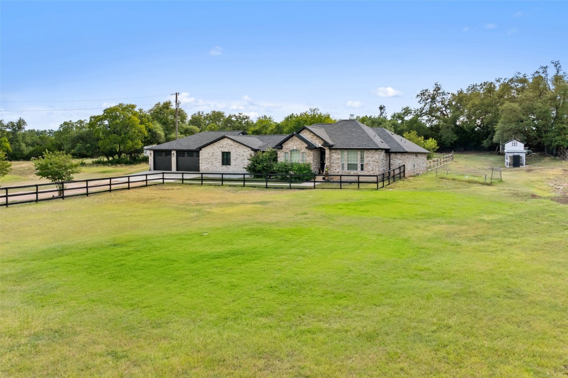 213 Beauchamp Road Dripping Springs, TX 78620 - Photo 2 of 40 a front view of a house with a yard and lake view