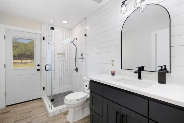 a bathroom with a double vanity sink toilet and shower