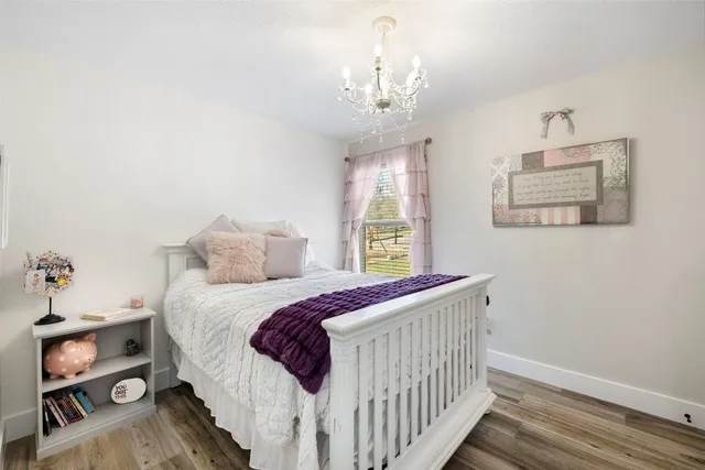 a bedroom with a bed and a chandelier