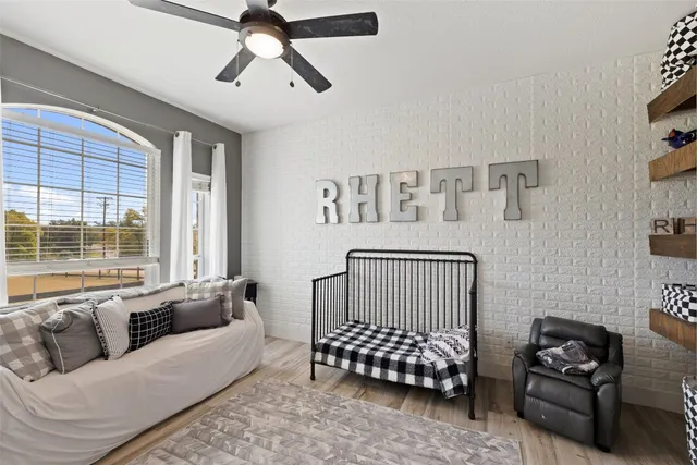 a bedroom with a bed couch and window