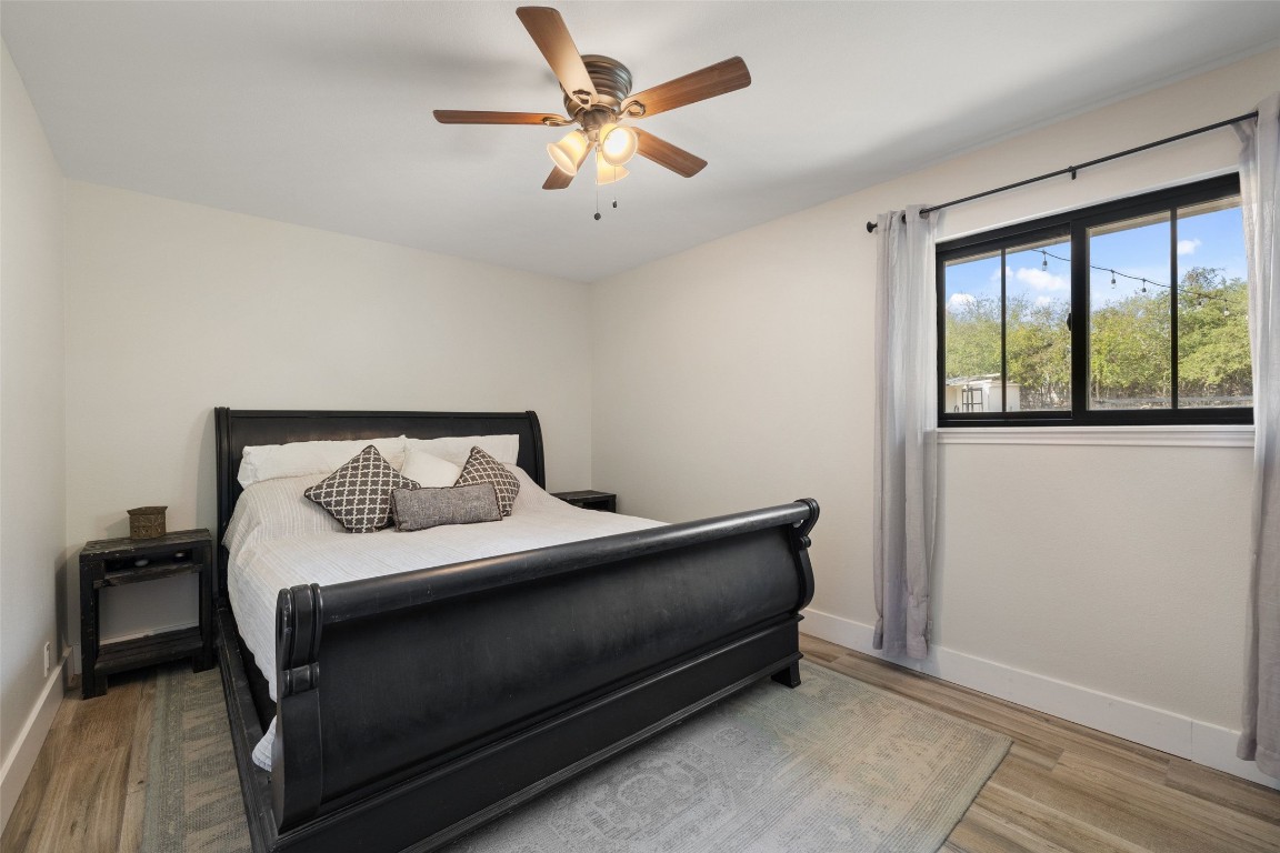213 Beauchamp Road Dripping Springs, TX 78620 - Photo 29 of 40 a bedroom with a bed and a large window