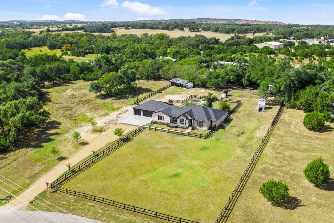 213 Beauchamp Road Dripping Springs, TX 78620 - Photo 3 of 40 a view of a swimming pool with a yard