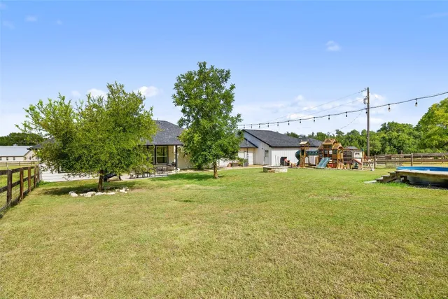 a front view of a house with a big yard