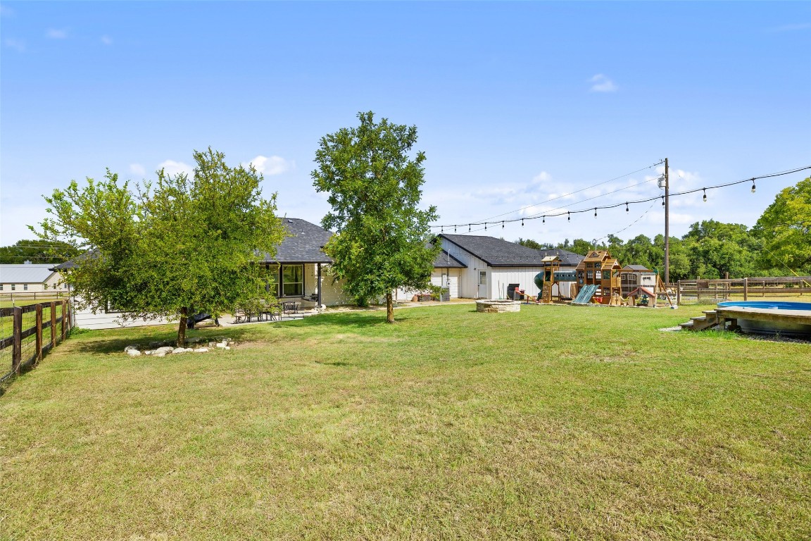 213 Beauchamp Road Dripping Springs, TX 78620 - Photo 32 of 40 a front view of a house with a big yard